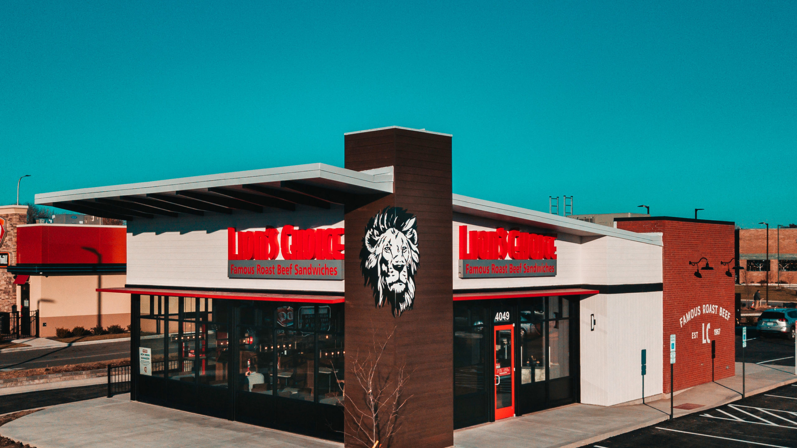 A photograph taken from above of a Lion's Choice Restaurant. The image is take from the corner of the building.