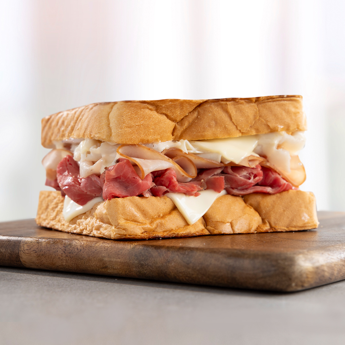 An image of a sandwich on a wood cutting board